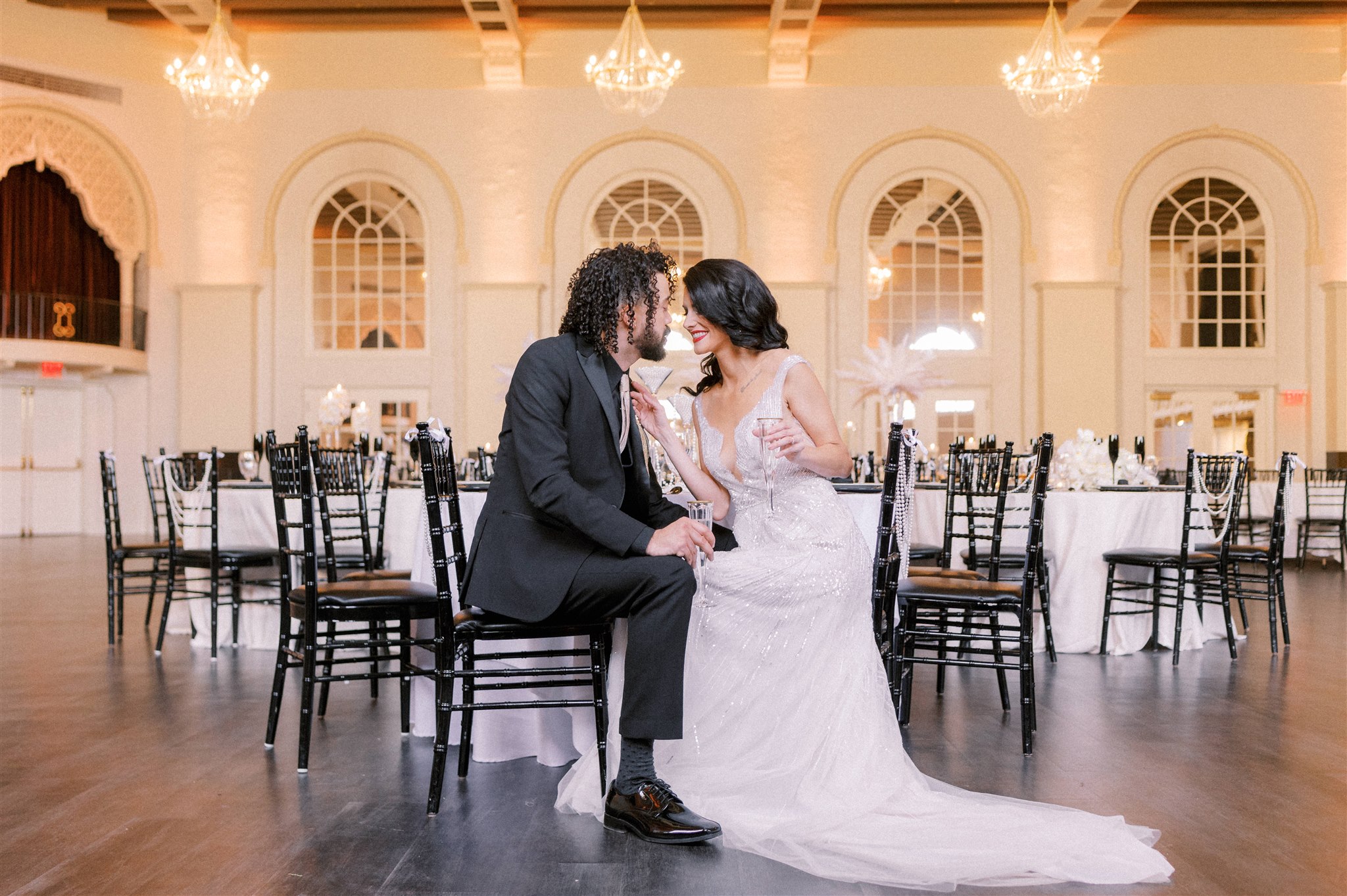 Bride and groom embracing on the dancefloor at The Leo Room in Omaha while seated